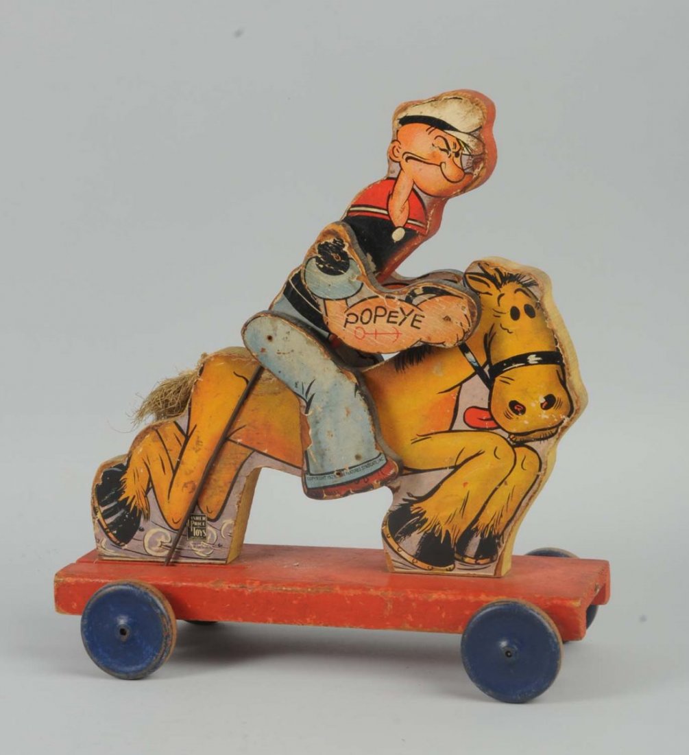 Fisher Price Paper on Wood Popeye the Cowboy Toy.: On platform. Popeye rides horse. All original. Marked "King Features Syndicate, Inc." Some scratching and some paper loss on edges. One side of top of horses head is missing about a quarter of an inch