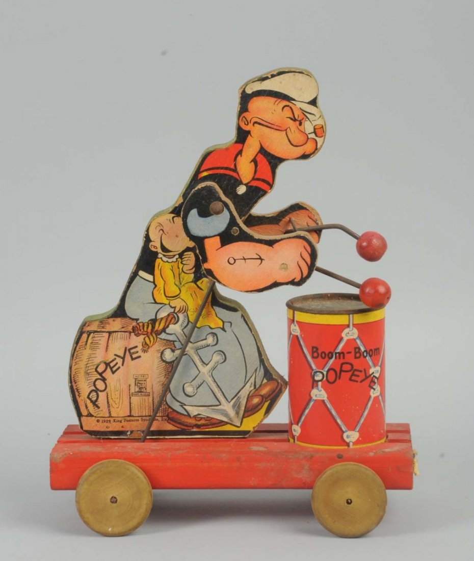 Fisher Price Paper on Wood Popeye Boom- Boom Toy.: When pulled, Popeye's arms go up and down and mallets hit drum. Original drum head. Drum head does have some oxidation. Marked "1929 King Features Syndicate, Inc." Some lining to paper litho and wear.