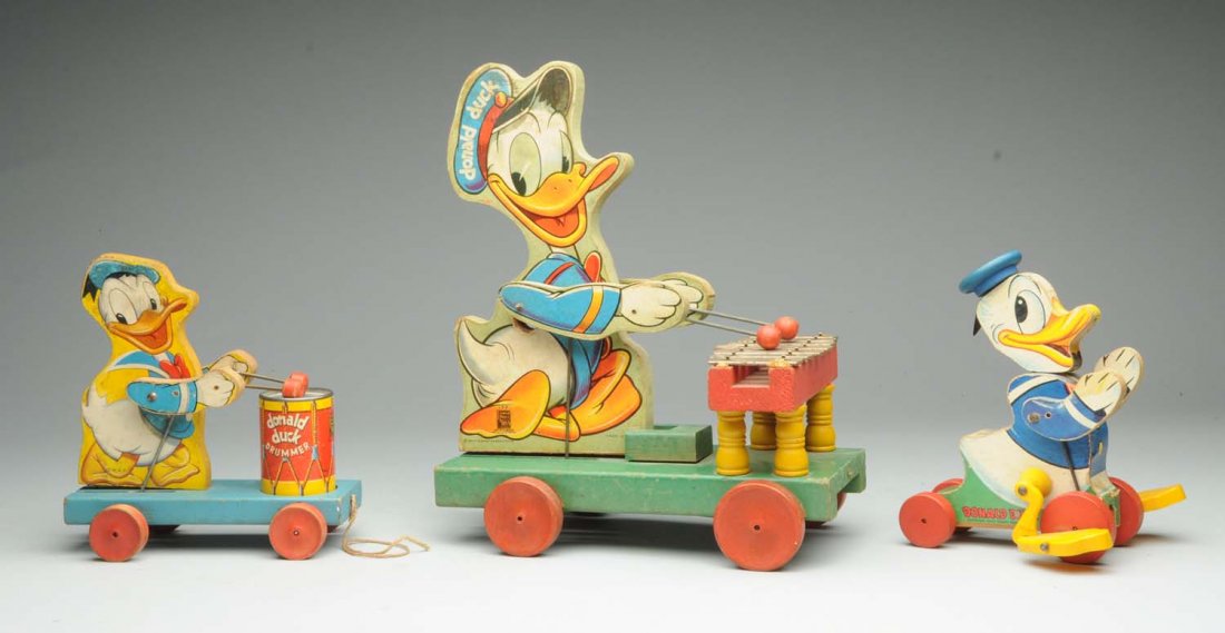 Lot Of 3: Fisher-Price Donald Duck Toys.: Marked 'Walt Disney Productions'. Lot includes: larger xylophone toy, smaller drummer toy, and a walking toy. Some pitting and wear to xylophone keys. General over-all wear. Condition (Good - Very Goo