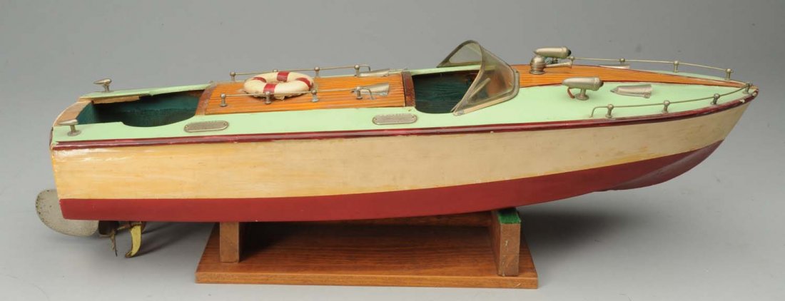 Battery-Operated Wooden Boat.: With original top. Marked 'TMY' on motor. Some general edge wear. Shellac on sides of hull. Comes with wooden stand. Condition (Very Good). Size 18" L.