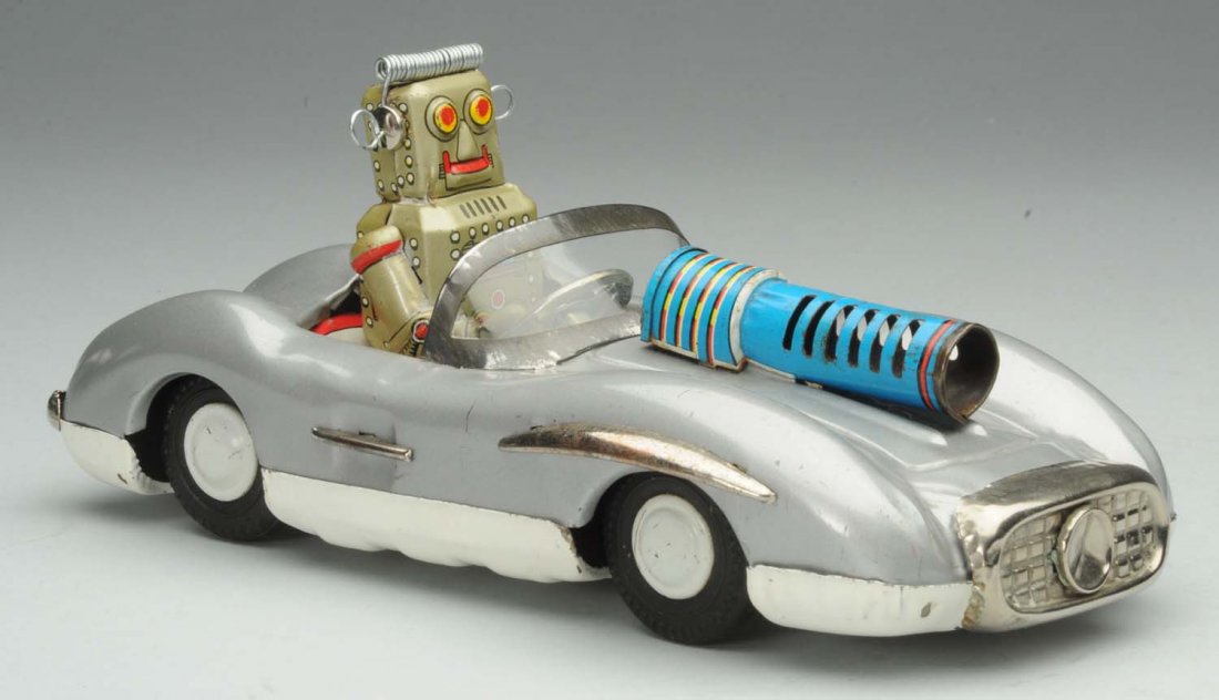 Tin Litho Friction Robot Car.: Japanese. Mercedes emblem on front. Working silver version. Some oxidation to bare metal parts and some scratching and wear. Front gun has tab broke off and is loose. Condition (Very Good). Size 8" L.