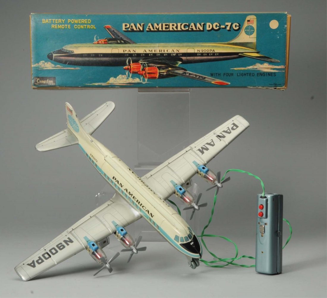 Japanese Tin Litho Pan American Airplane Toy.: Includes colorful original box marked "Cragstan". Also marked "TN. Made in Japan". Remote control activated. This is a Pan American DC-7C. Box does have some creasing and tearing. Plane has minor lith
