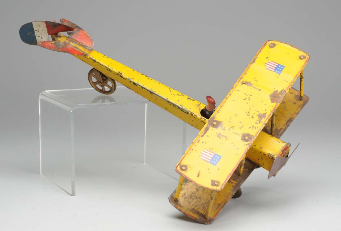 Pressed Steel Dayton Bi-Wing Airplane.: Fly wheel driven. Significant scratching and paint loss throughout. Includes original pilot. Condition (Good). Size 15" L.