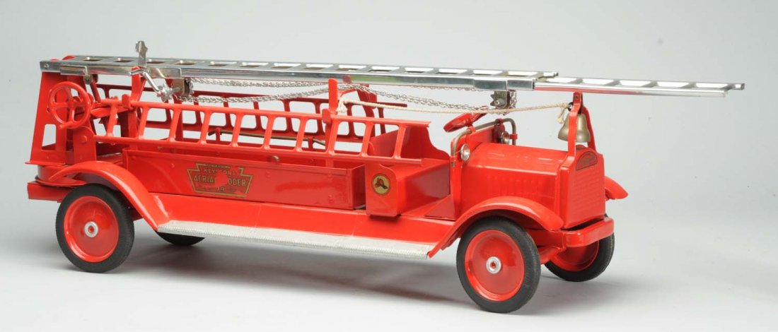 Pressed Steel Keystone Fire Truck.: Professionally restored. Has accessory ladders and bell. Flaking to some decals. Condition (Restored). Size 36" L.