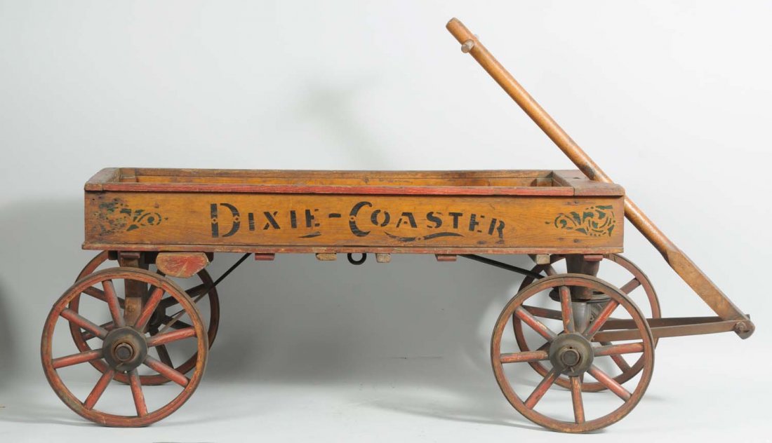 Early Wooden Dixie-Coaster Pull Wagon.: Wooden coaster with handle. Original iron and wood wheels. Stenciled "Dixie Coaster" on sides and on the back is stencil "Drissel & Eber's". Very unusual piece. Someone has cut a piece of glass to the