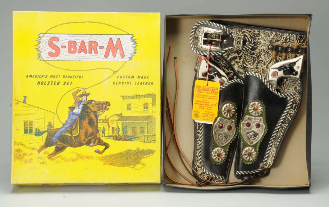 S-Bar-M Holster Set.: Set includes ornate leather holsters with original plastic bullets and two Hubley die-cast Western cap guns. Has original sales tag attached to holster set. Original box included. Condition (Near Mint