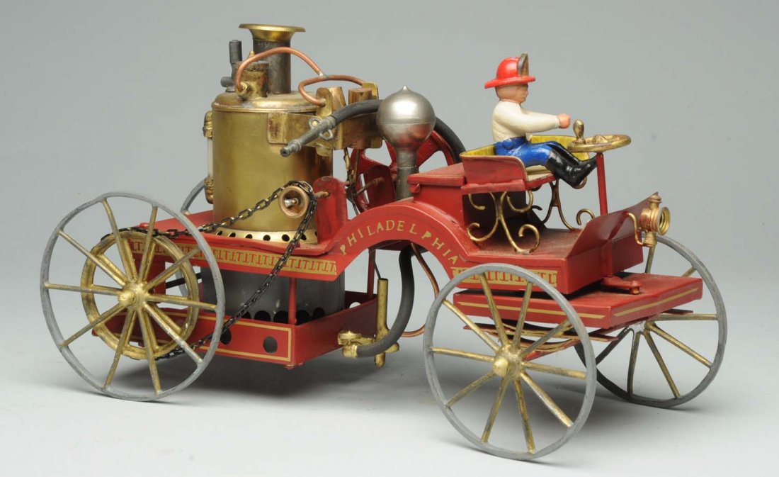 Shoener Live Steam Fire Pumper.: Pressed steel and tin. Nicely detailed model. Includes original driver. Condition (Near Min). Size 14" L.