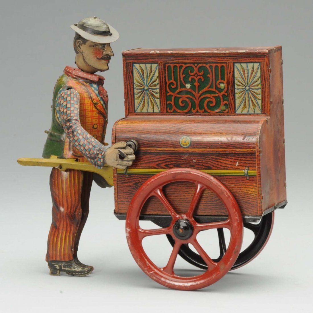 German Tin Distler WindUp Pete The Organ Grinder.: Missing original monkey. Scratching and wear throughout. Slight color loss and fading to litho. Some corrosion to underside. Original arm appears to be retabbed. Condition (Good). Size 11" L.