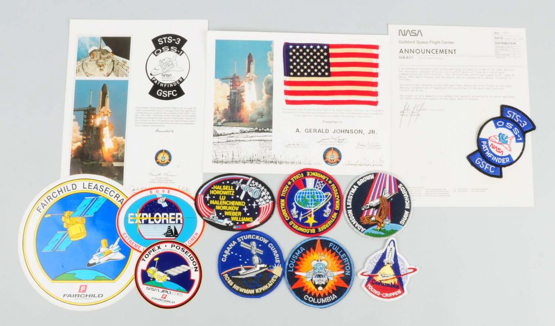 Space Shuttle Columbia Flight Carried Flag.: This lot includes a small American flag that was carried aboard the space shuttle Columbia. There are numerous other patches and stickers relating to the shuttle program in this lot as well. Condition