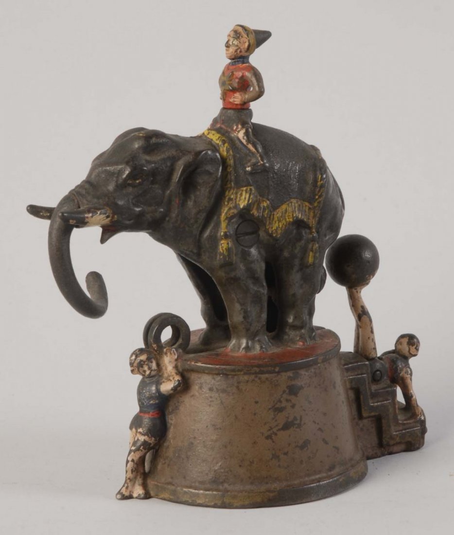 Elephant & Three Clowns Mechanical Bank.: Manufactured by J&E Stevens Company. Brown base variation. Working condition. There are paint scratches and loss throughout, otherwise, it is painted in black, brown, tan, yellow, and red colors. The