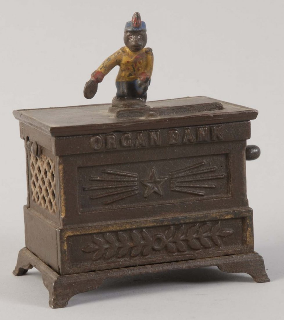 Organ Miniature Mechanical Bank.: Manufactured by Judd Manufacturing Company. Working condition. There are minor paint chips and scratches throughout. The bank is painted in dark green and yellow colors. It is preserved extremely well