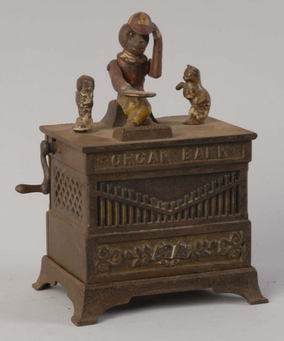 Organ Bank.: With dancing cat and dog. Working condition. Manufactured by Judd Manufacturing Company. There are some paint scratches and loss throughout, especially to the figures. It is painted brown in color and
