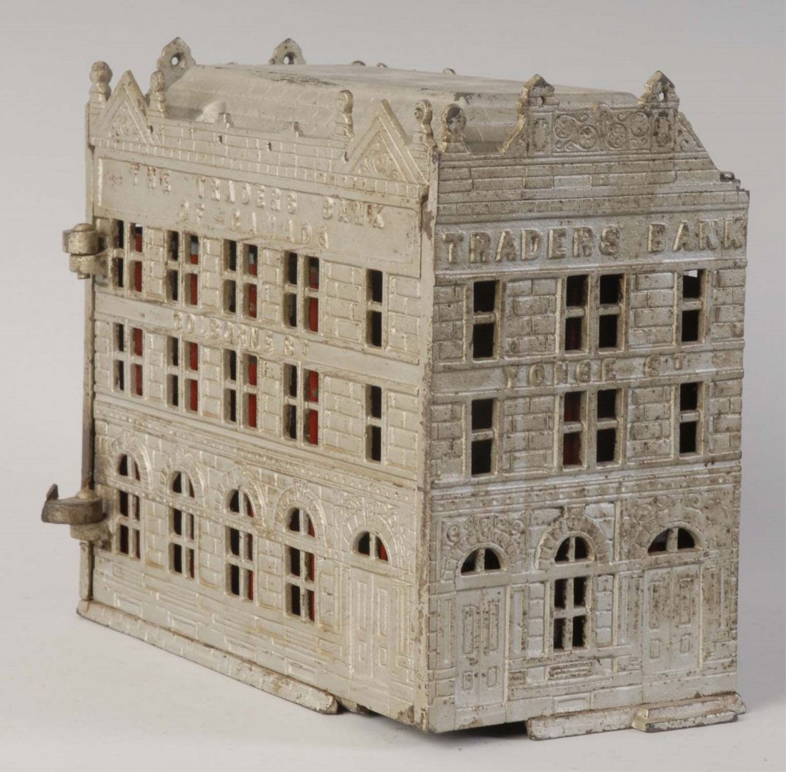 The Traders Cast Iron Still Bank.: Manufactured in Canada. Comes with original lock and original box. Cracked on one corner of building and missing small piece. There are some paint chips, scratches, and fading. Otherwise, it is painte