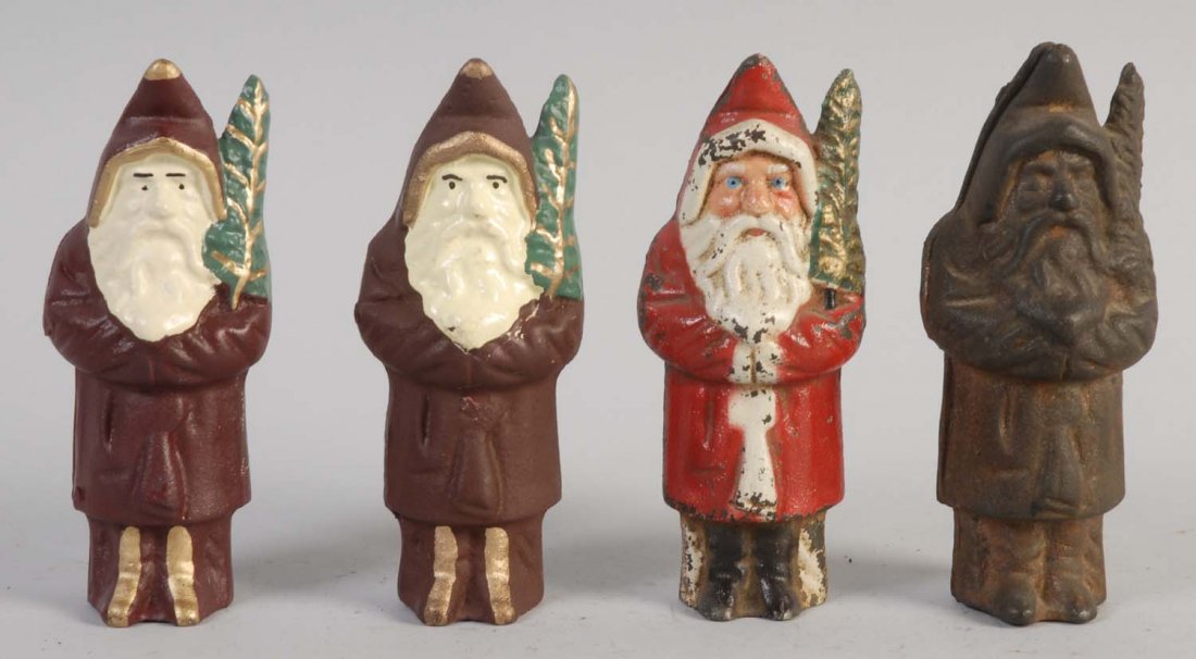Lot of 4: Cast Iron Santa Claus Still Banks.: Later production. All banks have some paint loss and scratches, and are painted in nice brown, white, green, and red colors. All banks are preserved excellently. Condition (Excellent). Size Largest: 6