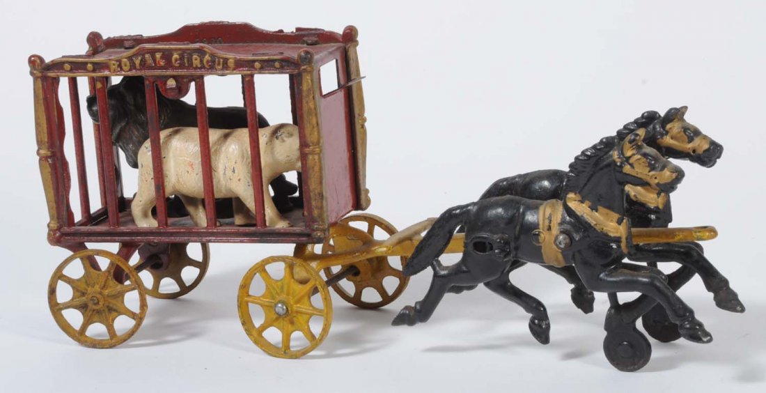 Cast Iron Circus Wagon.: Includes two horses, a lion, and a polar bear. The wagon is embossed "Royal Circus". There are some minor paint scratches throughout, but the wagon and animals are painted in red, yellow, and black. T