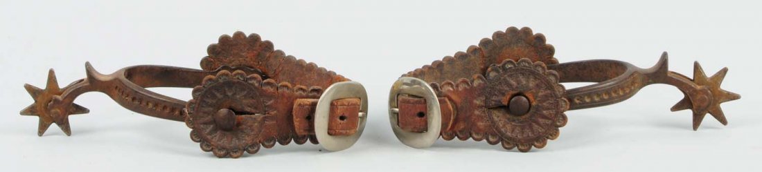Pair of Tooled Leather & Cast Iron Spurs: This pair of spurs has moderate wear, but the leather is nicely tooled. Condition (Very Good). Size 8" L.