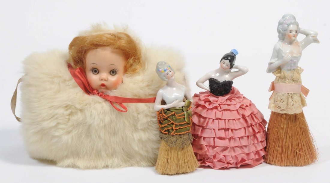 Lot of 4: Dolls.: Includes two porcelain dolls and brushes, one soft head muff, and one pin cushion. Condition (Excellent). Size Largest: 6 - 1/2" T.