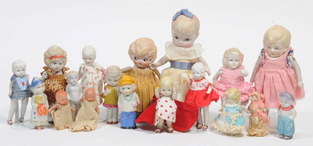 Lot of 18: Japanese All-Bisque Dolls.: Some have molded clothing and others are dressed. Some are not mobile and others are jointed. This is an interesting lot of small dolls. Condition (Fair). Size Largest: 8" T.