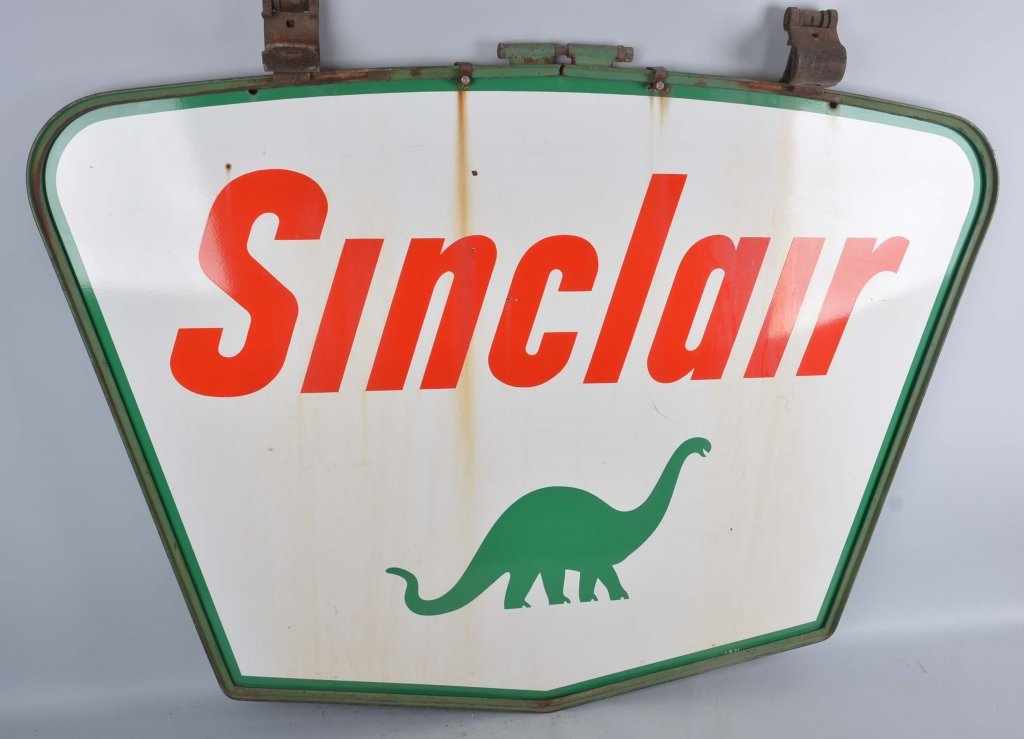 Sinclair Diecut Sign.: This is a double sided porcelain die cut sign with the Dino logo and the original hanging frame. The back has some rust staining that may clean off. It is dated 1961, with nice color and gloss. It is