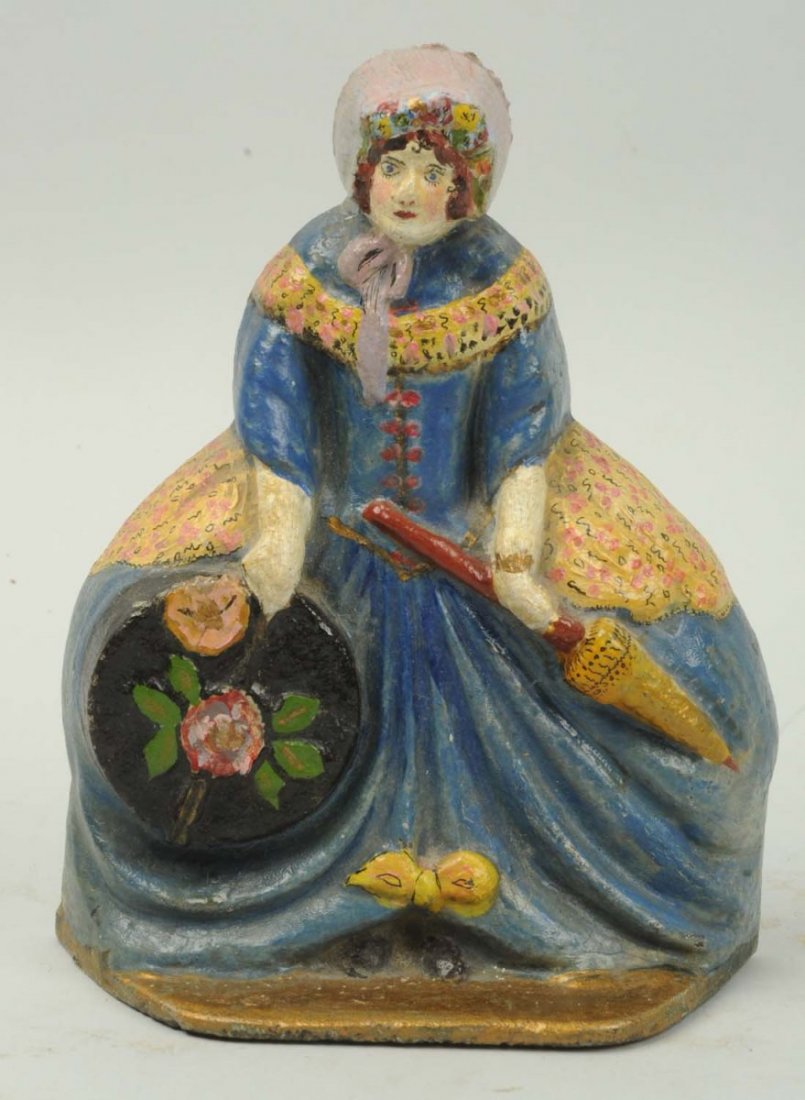 Cast Iron Lady with Hat Box & Parasol Doorstop.: Numbered "30". Repainted. Condition (Very Good). Size 7" T.