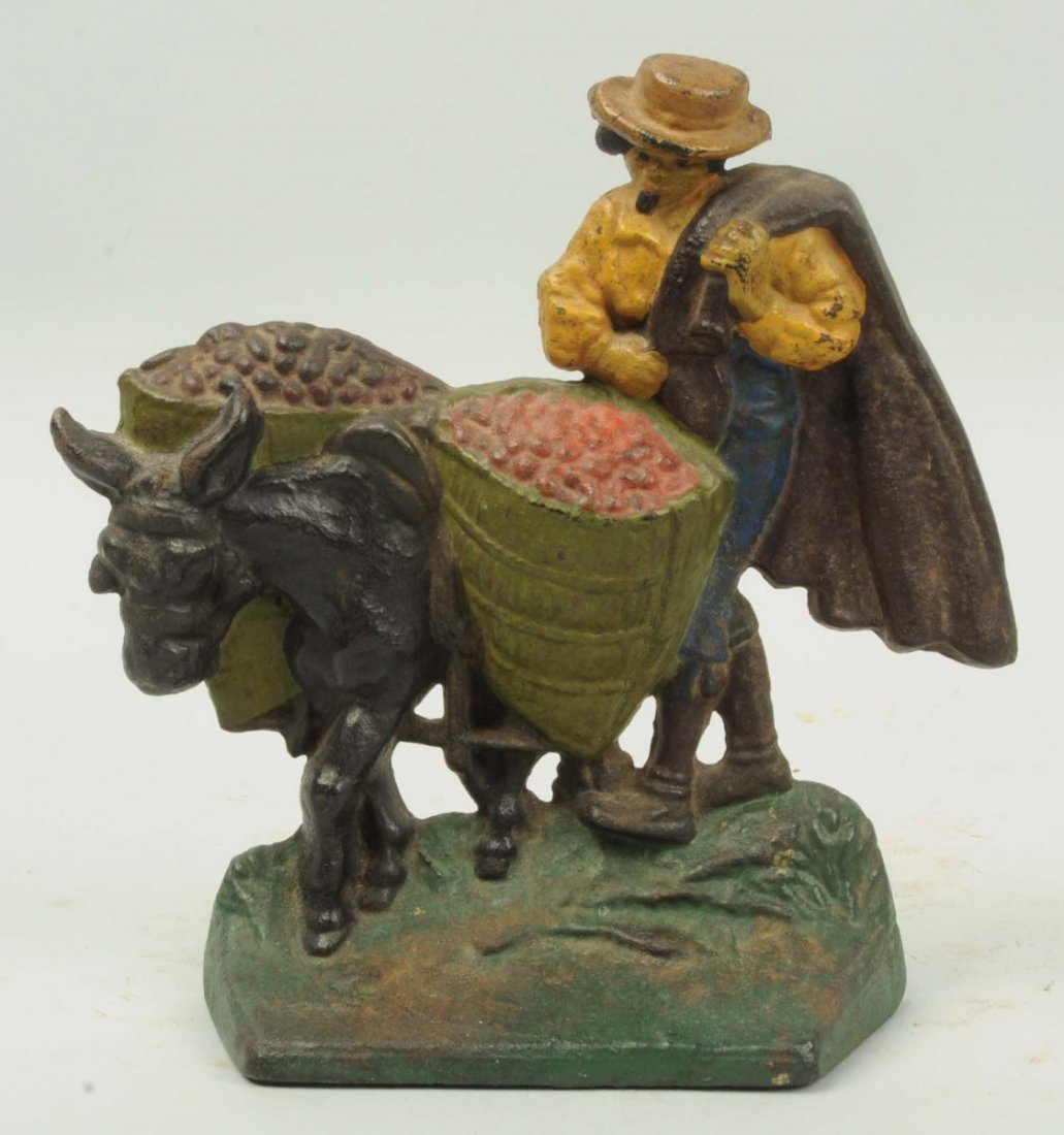 Cast Iron Olive Picker Doorstop.: By Hubley. Repainted. Condition (Good). Size 7 - 5/8" T.