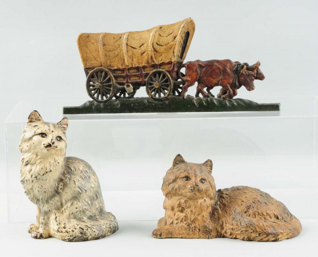 Lot of 3: Cast Iron Doorstops.: Includes an oxen and wagon, and two cat cast iron doorstops. Condition (Good - Very Good). Size Largest : 9 - 1/4" T.