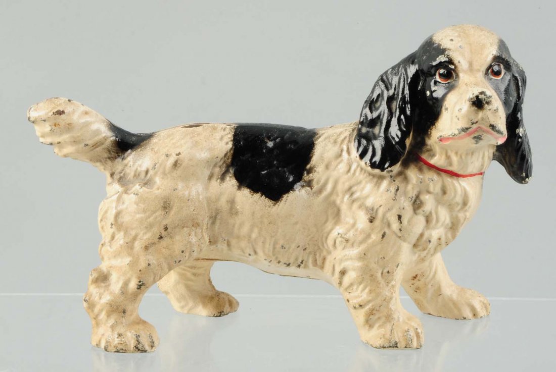 Cast Iron Cocker Spaniel Dog Doorstop.: Made by Hubley, full-figure. Black and white color variation. Condition (Very Good). Size 6 - 7/8" T.