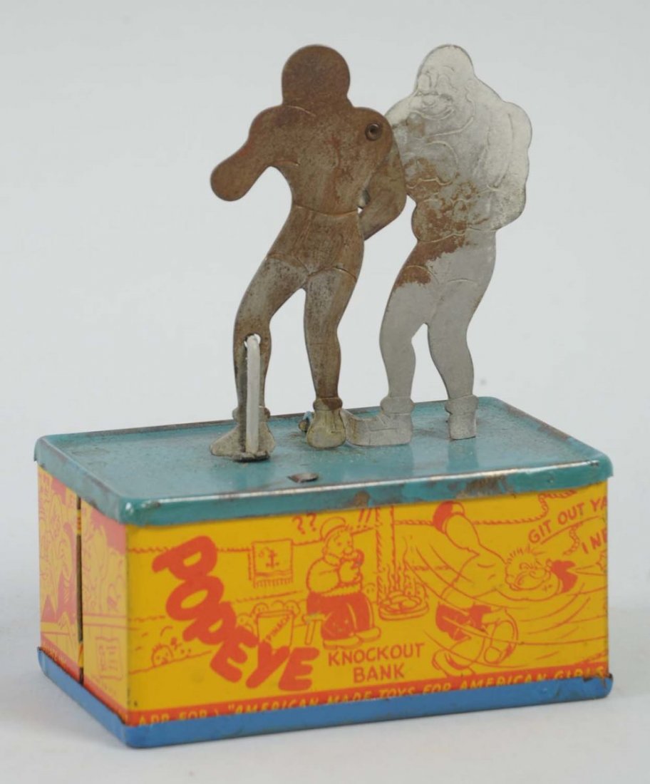 Knock Out Tin Still Bank.: Made by Straits Mfg. Co. The bank has slight oxidation to the boxing figures and minor litho scratches to the base. Otherwise, the sides of the base have nice litho colors depicting Popeye boxing and