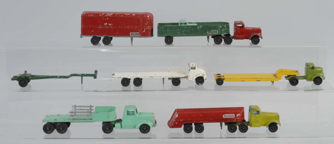 Lot of Diecast Trucks.: Lot includes various trucks, a tractor-trailer, two lumber trucks, two flat trucks, and a tank. They are made by Ralstoy Company. All trucks have significant paint loss and chips throughout. Otherwise