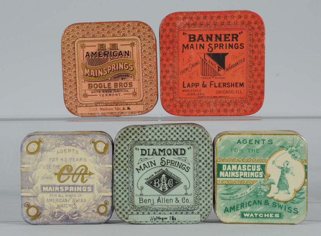 Lot of 5: Mainspring Round Corner Tins.: Colorful vintage mainspring tins; Banner, C.R. American, Diamond and Damascus. Condition (Fine Plus). Size Largest: 3 - 1/2" L.