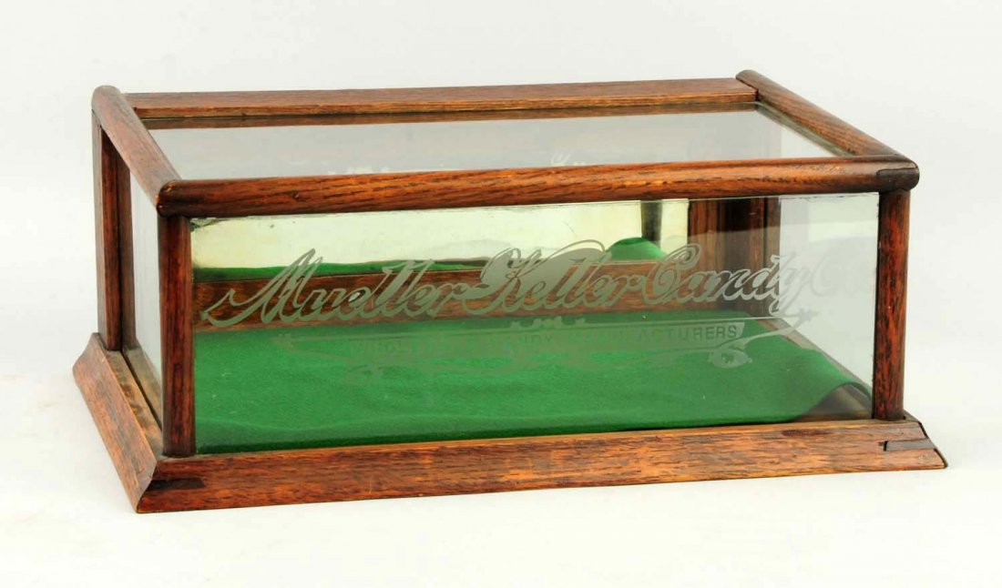 Small Mueller Keller Candy Co. Showcase.: Oak, in old Finnish tone, with acid etched front. Not a common find and only lighter wear. Condition (Excellent). Size 15 - 1/4" x 10 - 1/4" x 6 - 1/2".