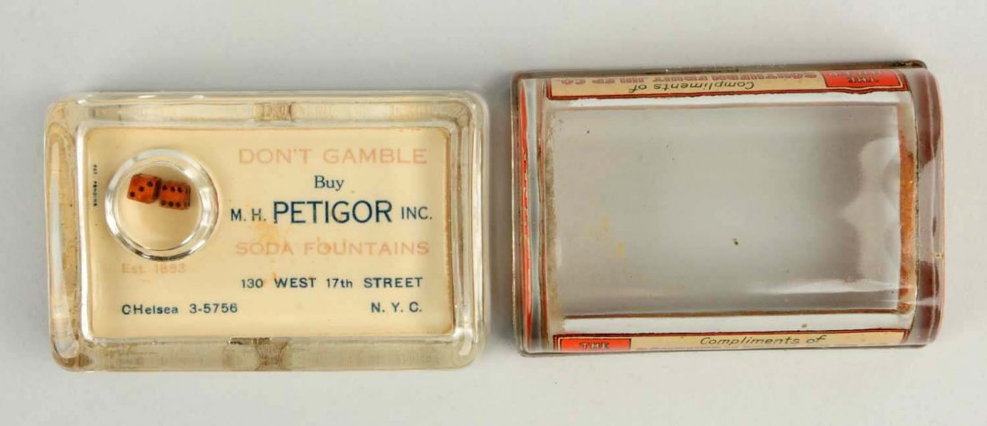 Lot of 2: Soda Related Glass Paperweights.: One for Petigor Soda fountains and the other for Southern Fruit Julep Company. The latter piece is empty inside with light wear on both. Condition (Excellent). Size 4" L.