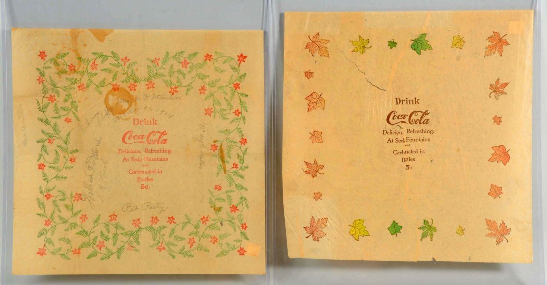 Lot of 2: Circa 1900 Coca-Cola Rice Paper Napkins: A few tears and wrinkles on the one with the leaves. The red and green napkin has a few stains and some pencil writing with signatures which are dated 1904. Condition (Very Good). Size 17" L.