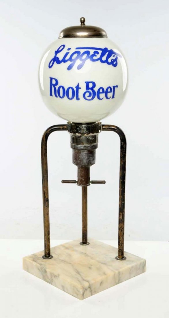 Early Liggett’s Root Beer Syrup Dispenser.: Made by Multiplex, c. 1900, of marble, metal and glass. Complete with lid and displaying moderate wear overall. Condition (Very Good - Excellent). Size 22" T.