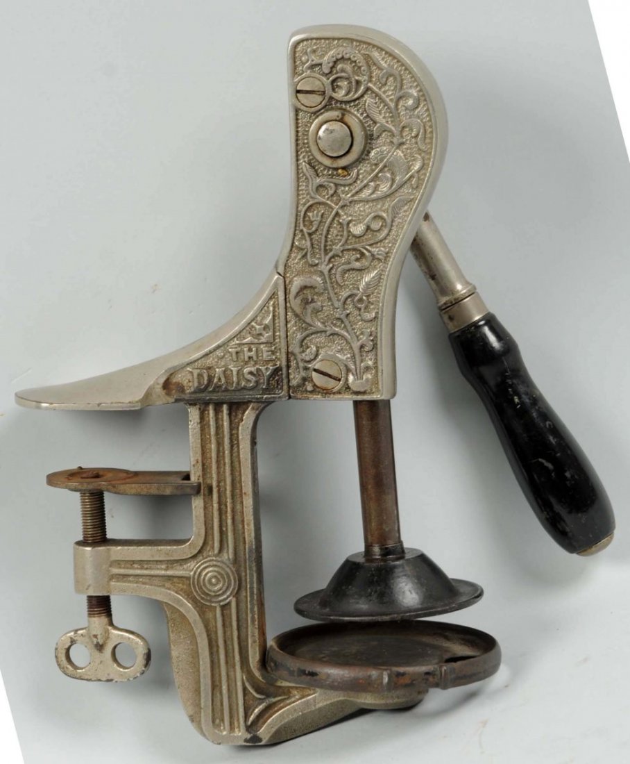Early Daisy Counter Juicer.: Designed to bolt onto the counter with a lever handle. Attractive piece with nice embossing on the metal parts of the body. Moderate overall wear. Condition (Very Good). Size 12" T.