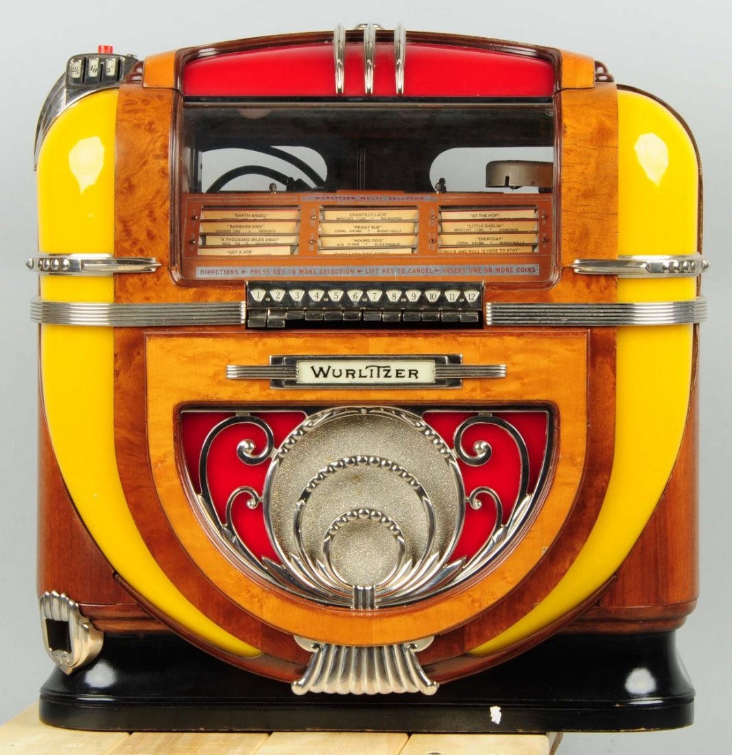 Wurlitzer. Model 71 Counter Jukebox.: Beautiful example and appears to be as strong a display example as you are likely to find. Includes keys, and exhibits only light wear and wood checking upon close examination. Untested. Condition (Ex