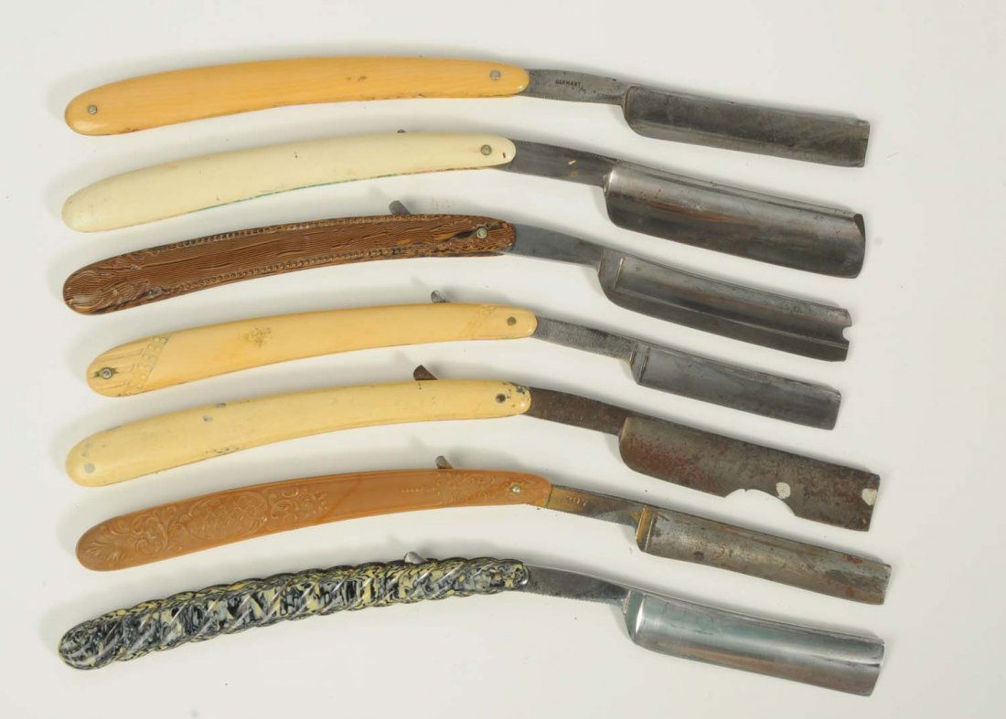 Lot of 7: Molded Celluloid Razors.: Lot includes: a Wadsworth with standing buck handle; a white and blue Triton Solingen with windmill handle scene, which has surface rust; an Uncle Sam with three deer outdoor scene, which the blade ha