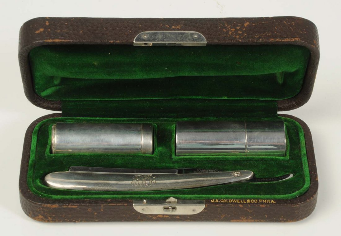 Gentlemen's Shavng Kit of Sterling Silver.: Contains Wade & Butcher razor, marked "England", with extended tang, tang etched “Improved Tang”, shaving soap container and compact shaving brush, all marked “Sterling” and possibly monogramm
