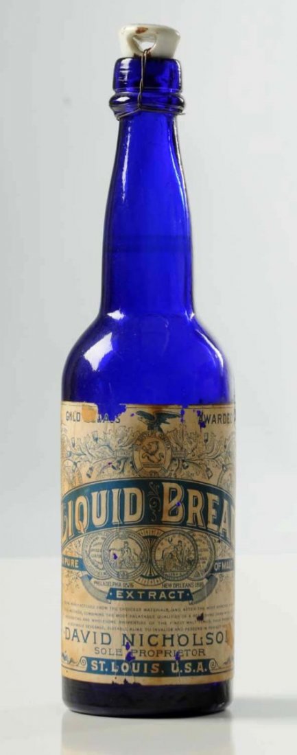 Early Cobalt Anheuser-Busch Beer Bottle.: Liquid bread beer bottle. Still has ceramic marked cap at top and most of the paper label remains on this rare bottle. Condition (Very Good Plus). Size 9 - 3/4" L.
