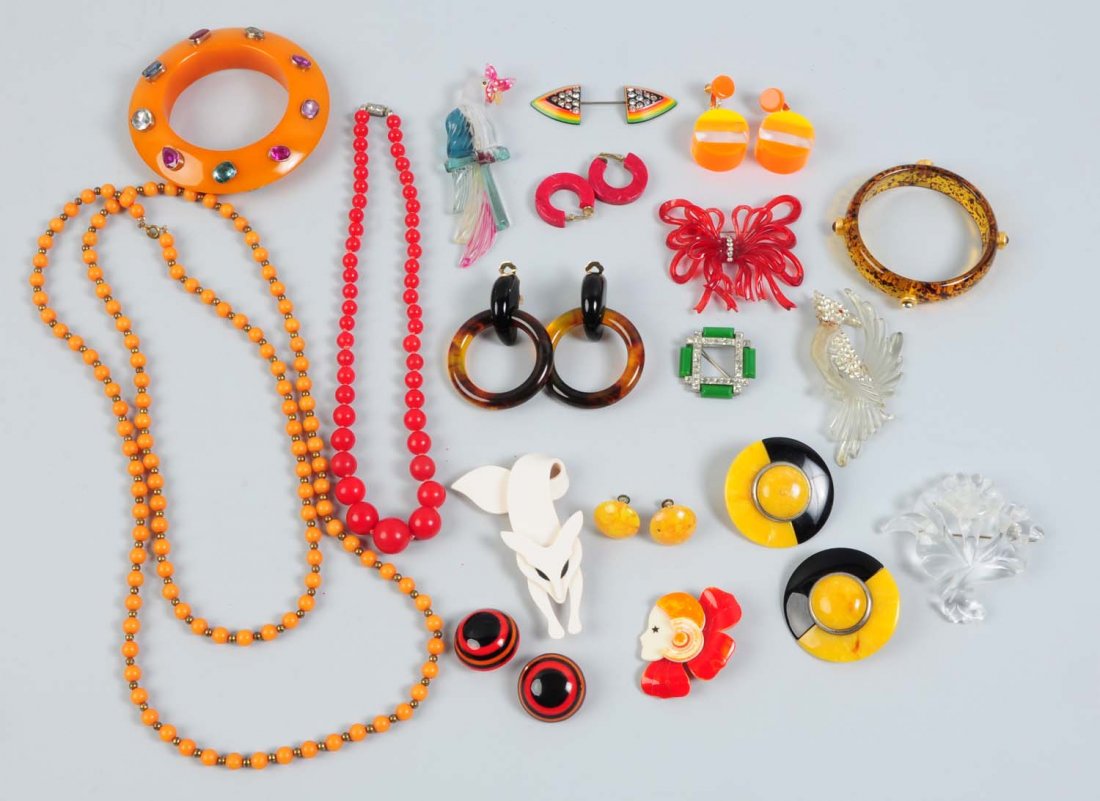 Lot of 18: Assorted Bakelite & Lucite Jewelry.: Includes two Lea Stein brooches, six pairs of earrings, three Lucite carved brooches, an Art Deco chrome and rhinestone green Bakelite brooch, an apple juice Bakelite bow brooch, two Lucite bracelets