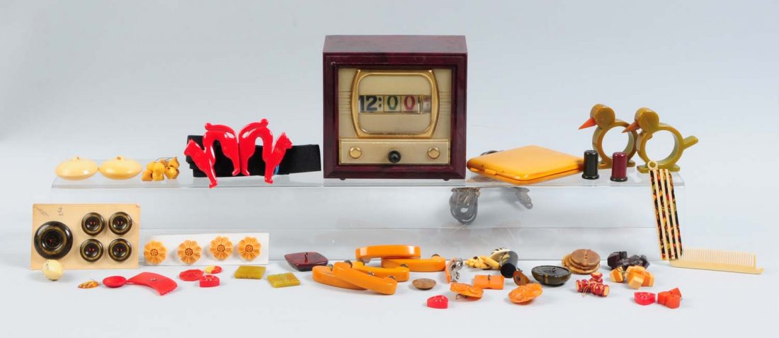 Bakelite Clock & Assorted Bakelite Pieces.: Includes napkin rings, buttons, a cigarette case, a comb, a belt buckle, butterscotch drawer pulls, and more. Condition (Good - Excellent).