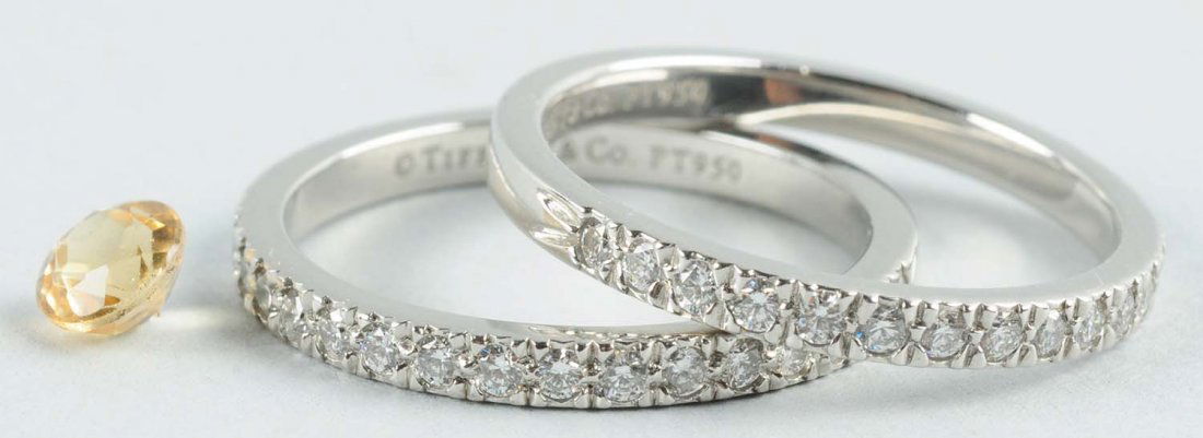Lot of 3: Jewelry Pieces.: Pair of Tiffany Platinum Eternity rings and a .25 carat yellow loose diamond. Size Ring Size: 6-1/2.