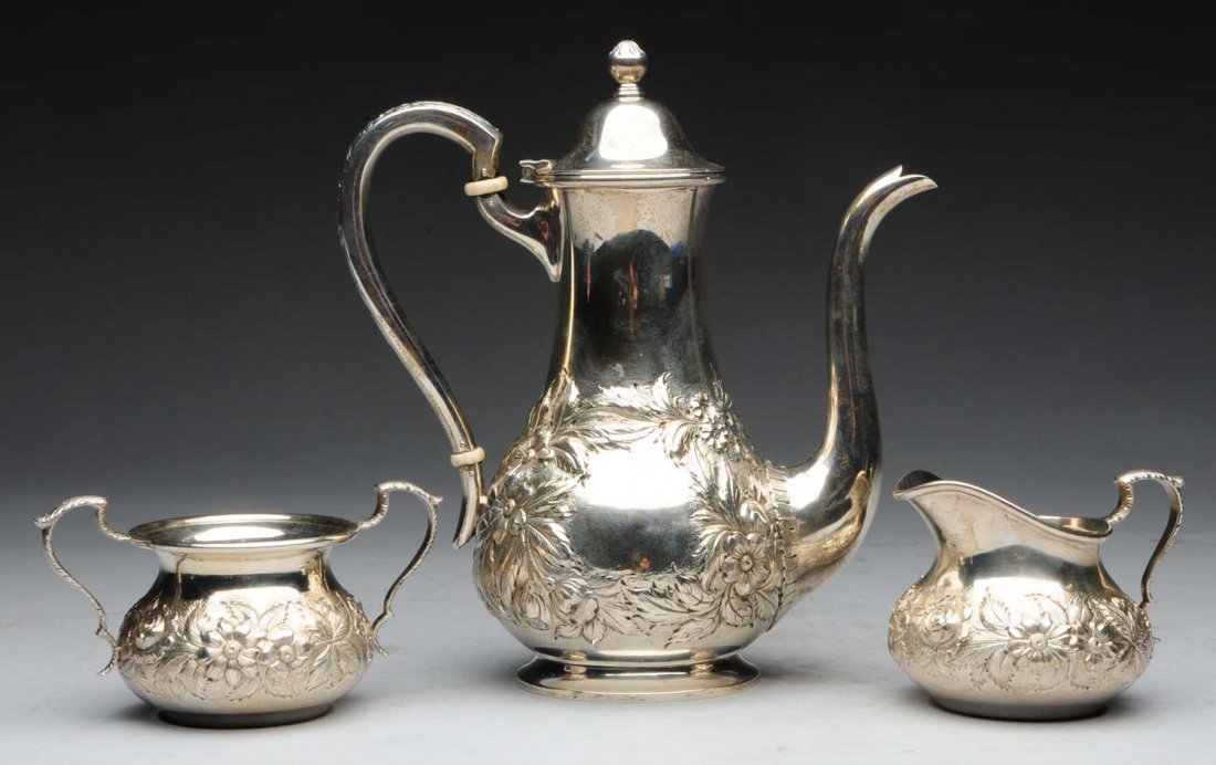 S. Kirk & Son Sterling Silver Repousse Set.: Set includes a teapot, sugar bowl, and creamer No. 418B. Hand decorated. Weight: 20.4 ozt.