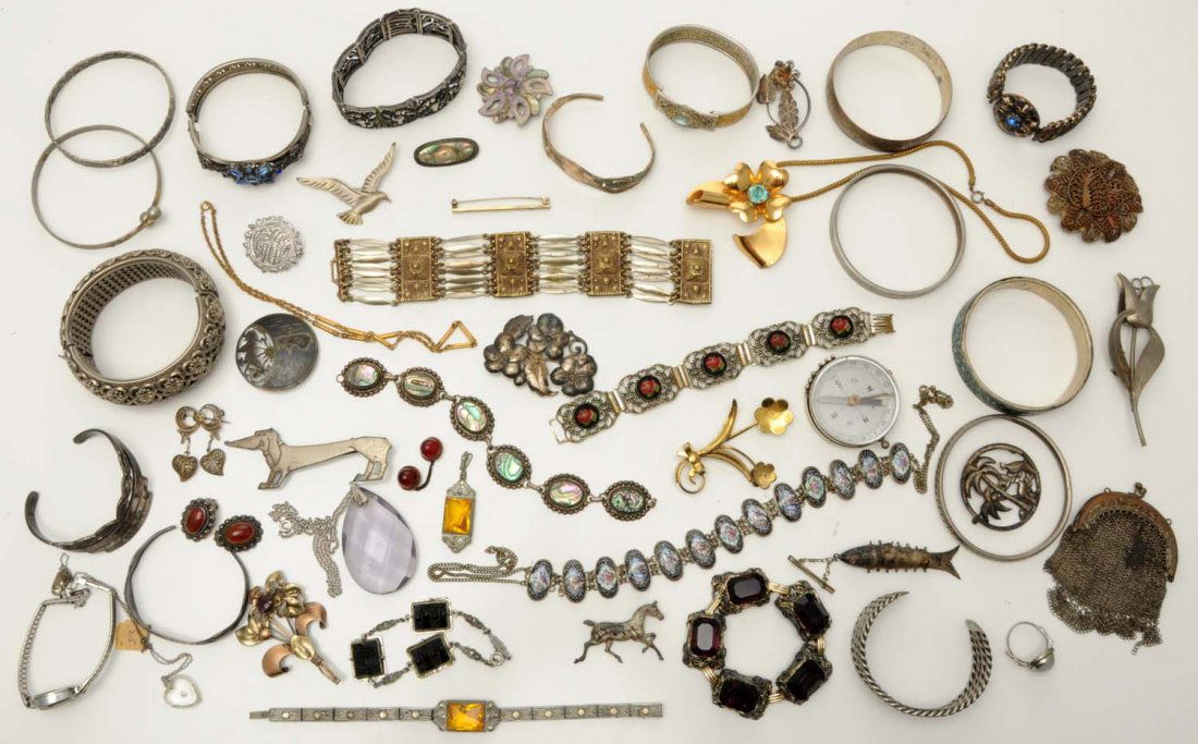 Large Lot of 23: Sterling Pieces.: Includes two American Indian bracelet, one silver coin match safe, rings, pins, bracelets, one pen knife, and two military pins. Weight: 9 ozt.