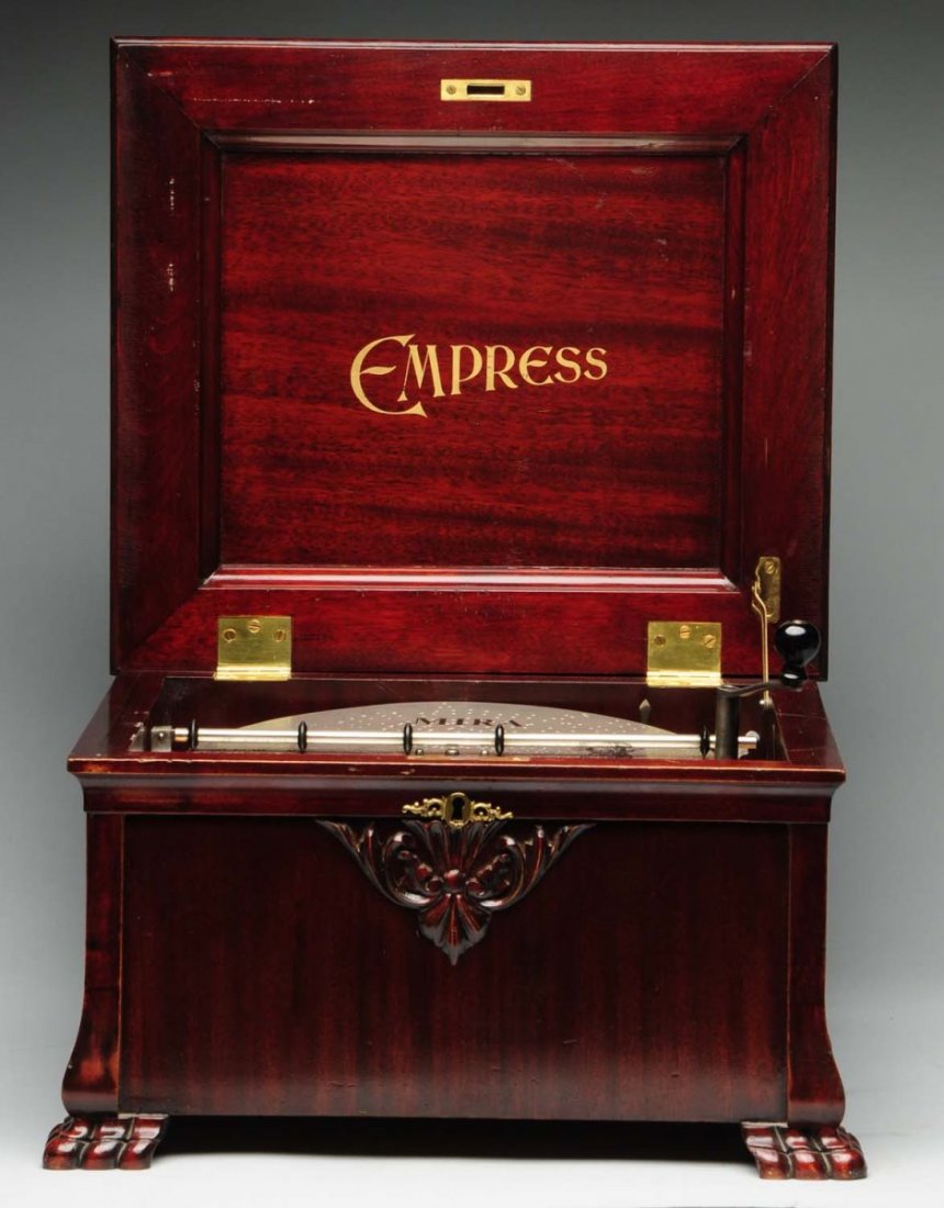 Empress12" Disc Music Box.: Musical movement made by Mira for the American market. Single comb. 11 discs included. All teeth intact. Not original winding crank. Original finish on a nice case with claw feet. Plays and sounds nic