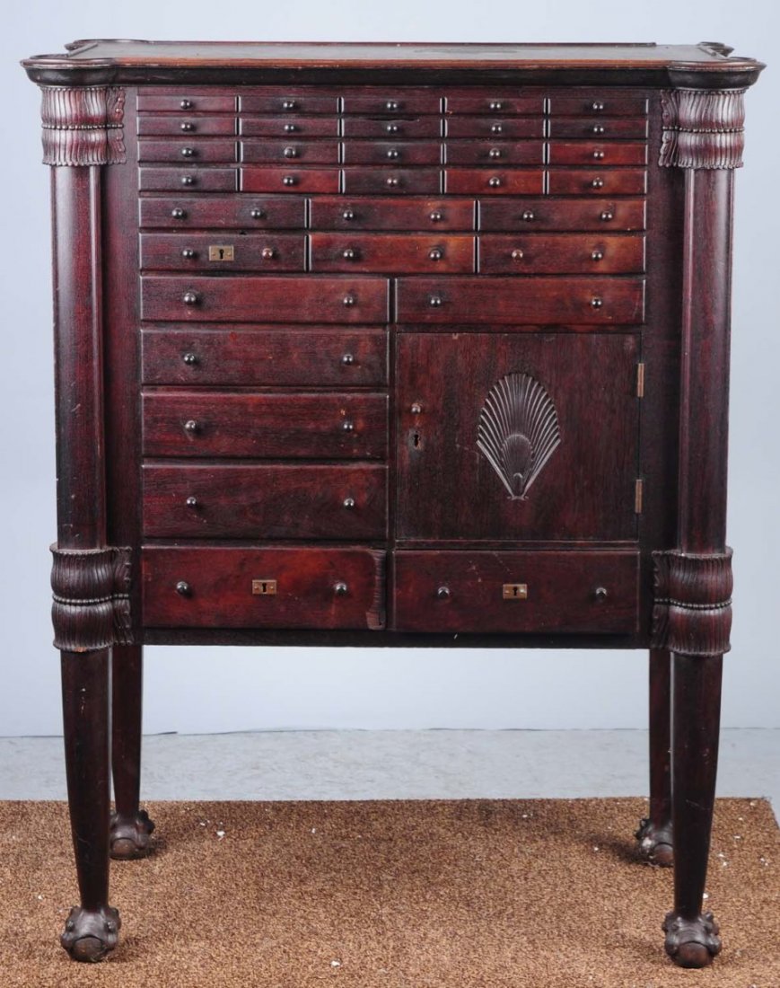 Large Wooden Dental Cabinet.: 1910. All original. With a shell pattern. Includes 32 drawers and a storage space with door. Condition (Excellent). Size 47 - 1/2" x 37 - 1/2" x 21".