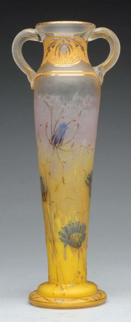 Daum Nancy Art Glass Vase.: The case has an intricate floral motif and a crack in one of the handles. Condition (Very Good). Size 11" T.