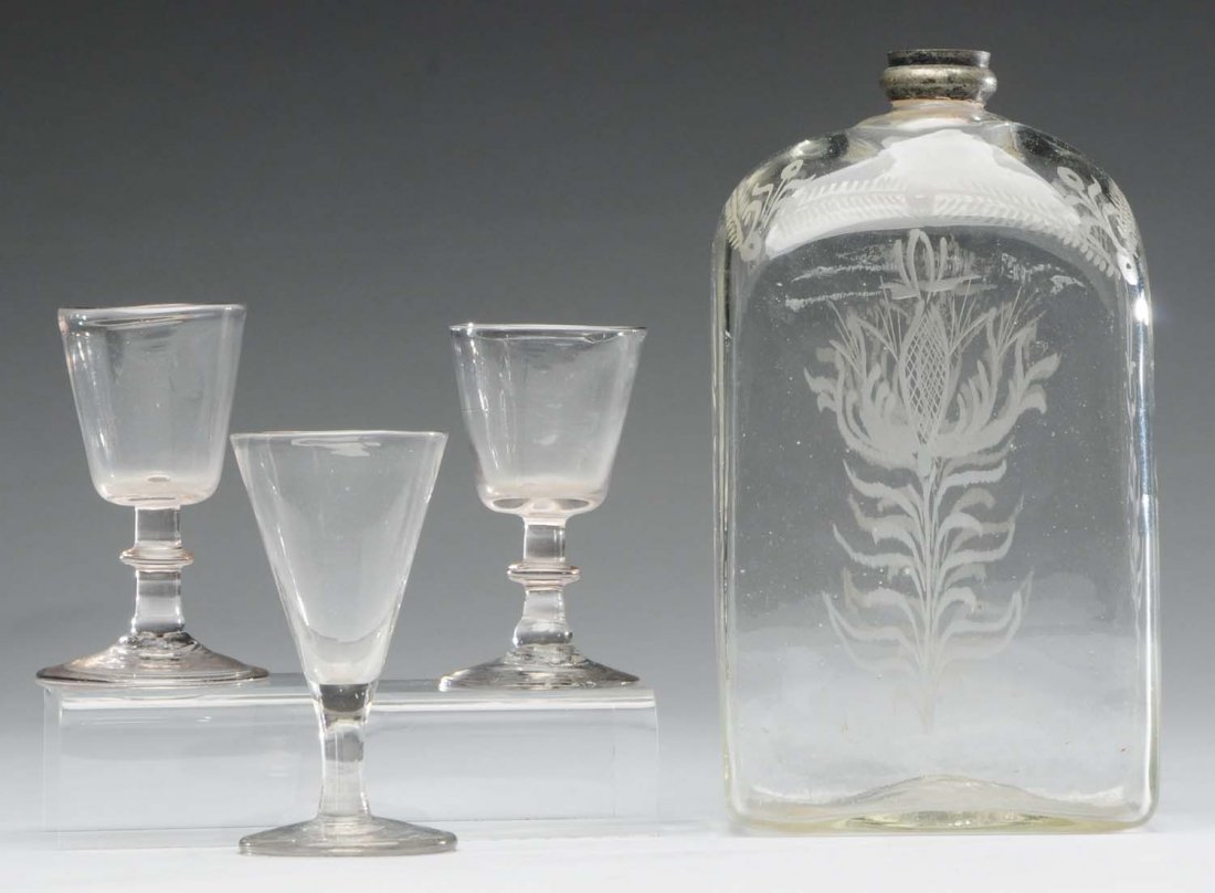 Stiegel Glass Bottle with Metal Top.: Bottle has etched flowers and includes three blown glass small goblets. Two match and one does not. Condition (Very Good). Size Largest: 8 - 1/2" T.