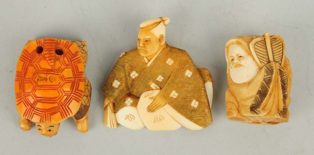 Lot of 3: Ivory Netsukes.: Two man figures, one with a turtle shell on his back. Both are signed and the pin is also signed. Size Largest: 2" T.