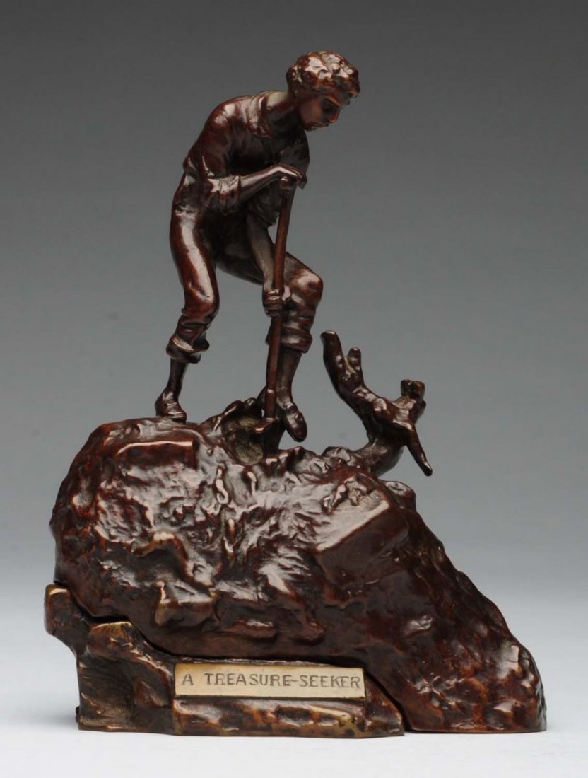Austrian Bronze Sculpture.: "A Treasure Seeker" bronze created and signed by Austrian artist Carl Kauba. The sculpture depicts a young boy digging for treasure, and when one lifts the top, it reveals a beautiful reclining nude w